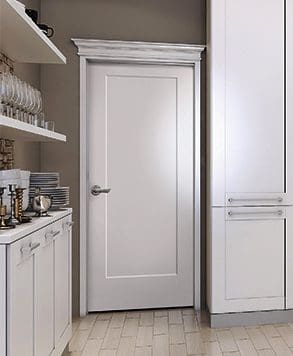 A white door in the middle of a kitchen.