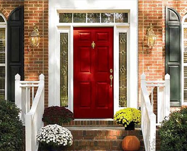 A red door is shown on the front of a house.